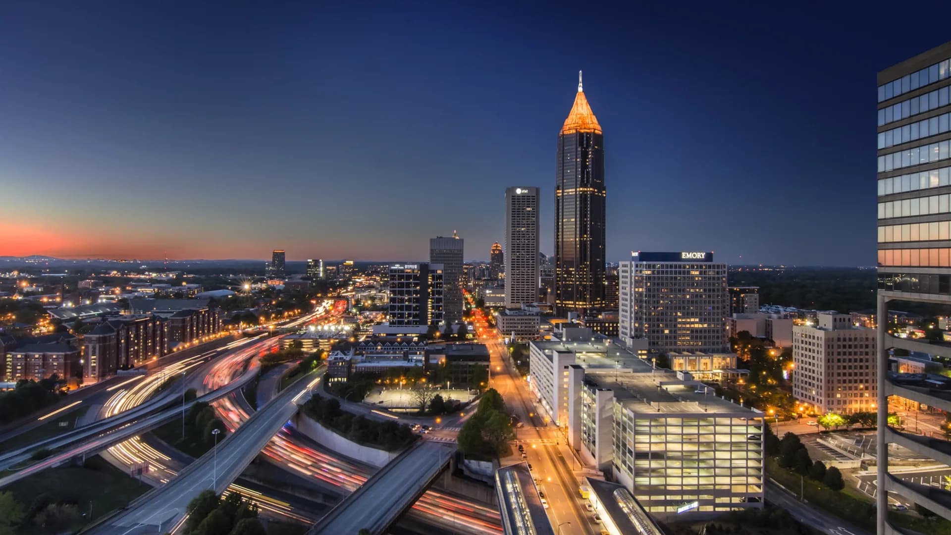 Midtown Atlanta at dusk, with Georgia business corridors and the city skyline illuminated