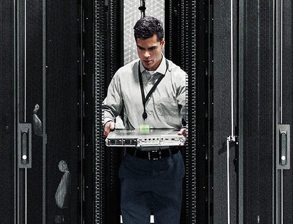 Technician installing network equipment in a server rack